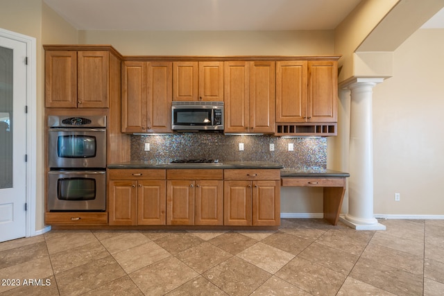 kitchen featuring appliances with stainless steel finishes, tasteful backsplash, and light tile flooring