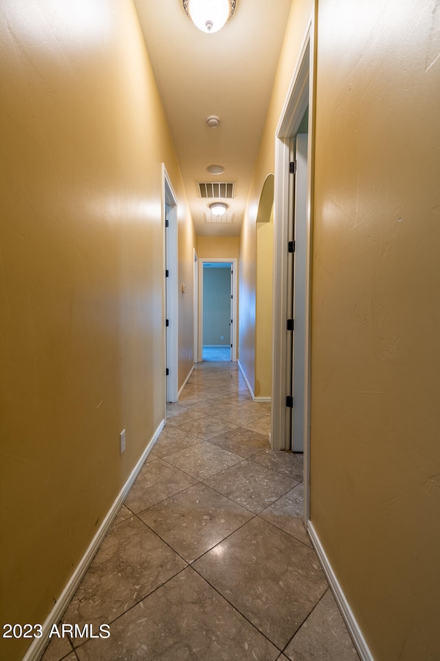 corridor featuring light tile floors