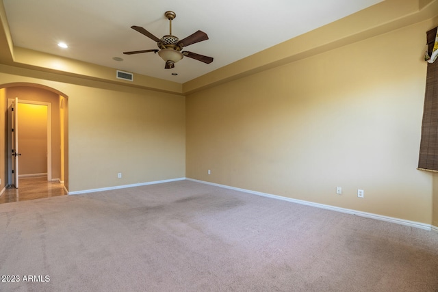 carpeted spare room with ceiling fan