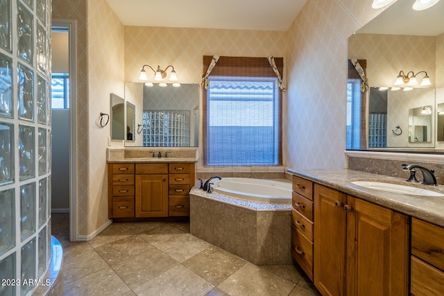 bathroom featuring a relaxing tiled bath, tile floors, dual bowl vanity, and tile walls