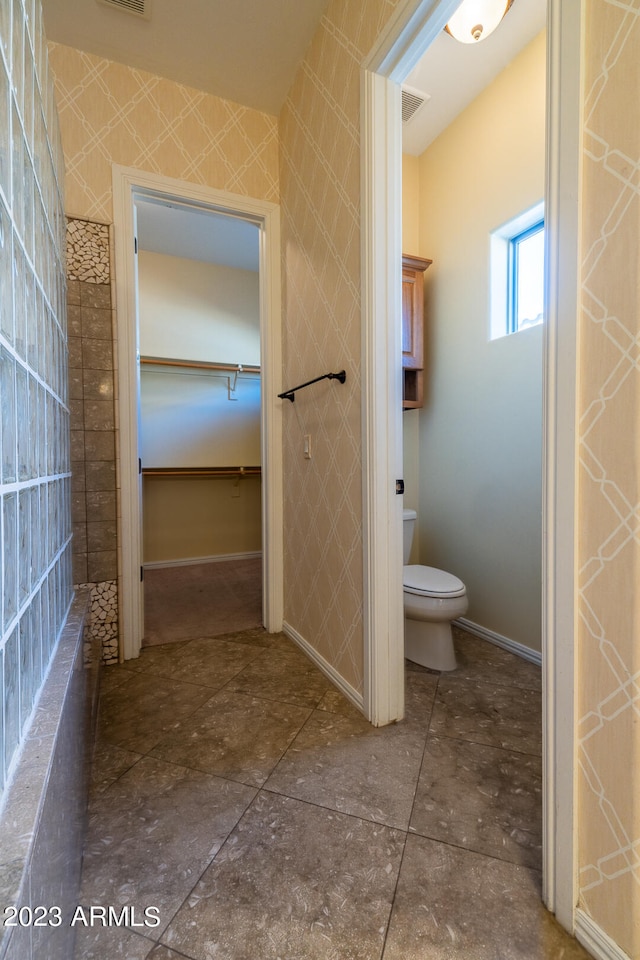 bathroom featuring toilet and tile flooring