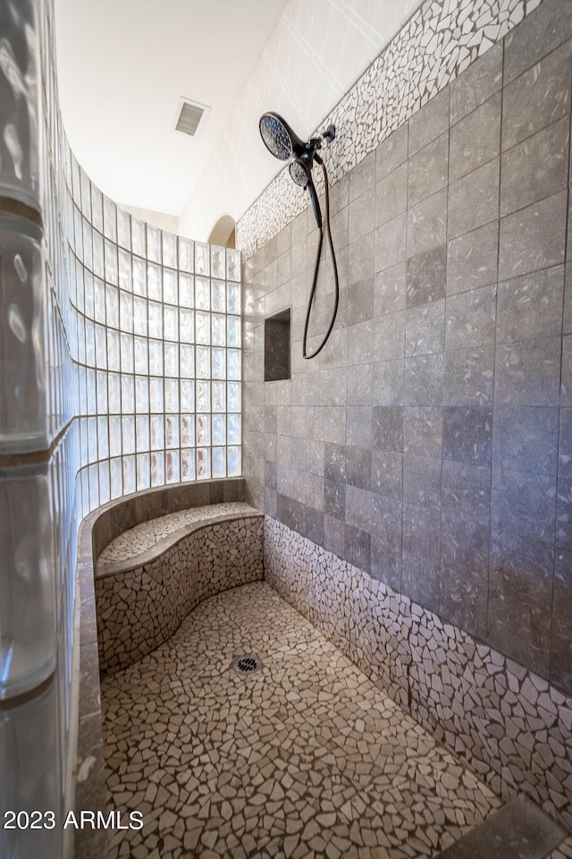 bathroom with tiled shower