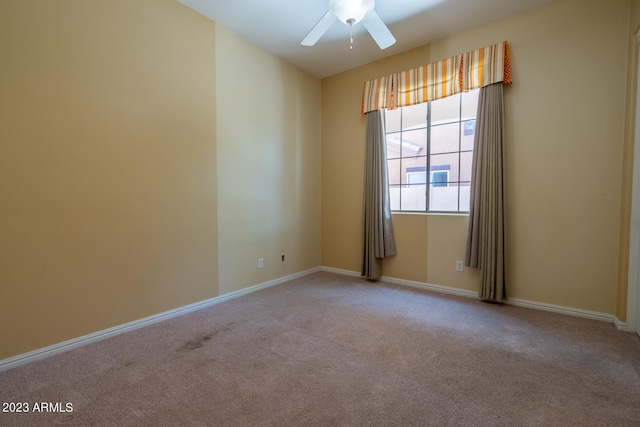 carpeted spare room with ceiling fan