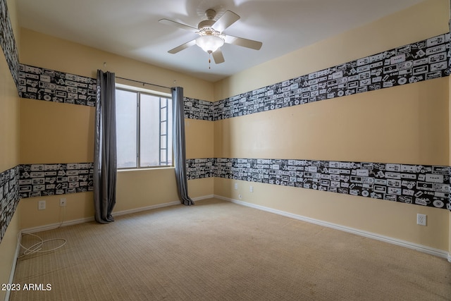 carpeted spare room with ceiling fan