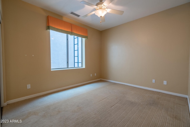 carpeted empty room featuring ceiling fan