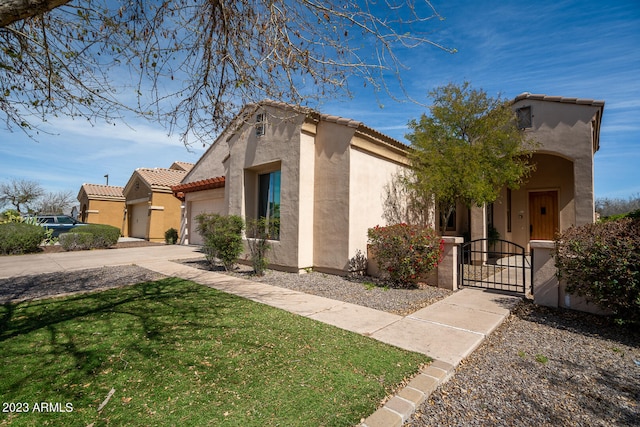 mediterranean / spanish house featuring a front yard and a garage