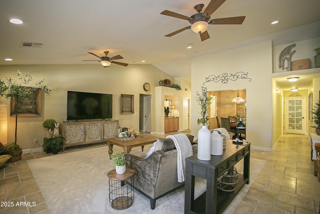 living room with ceiling fan and high vaulted ceiling