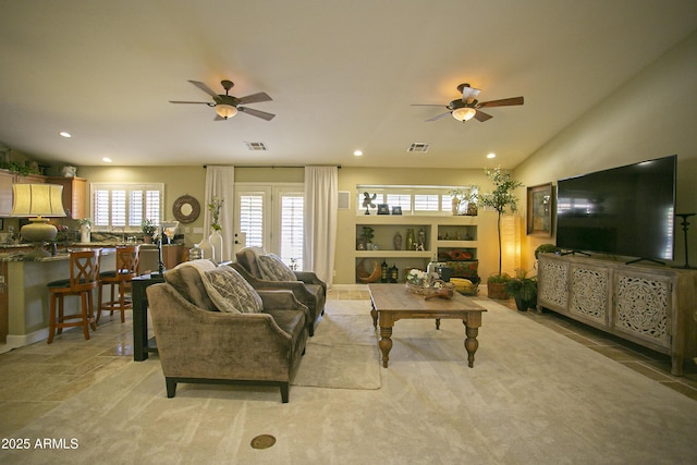 living room with ceiling fan, light carpet, and lofted ceiling