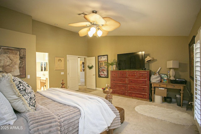 carpeted bedroom with ceiling fan, ensuite bathroom, and lofted ceiling