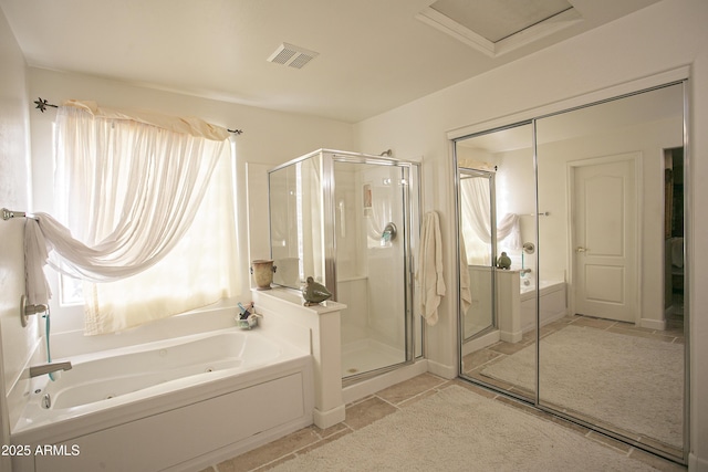 bathroom featuring plus walk in shower and tile patterned flooring