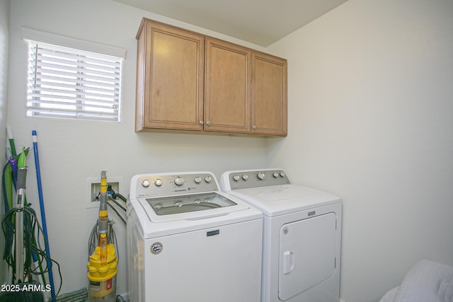 laundry area with cabinets and washer and clothes dryer