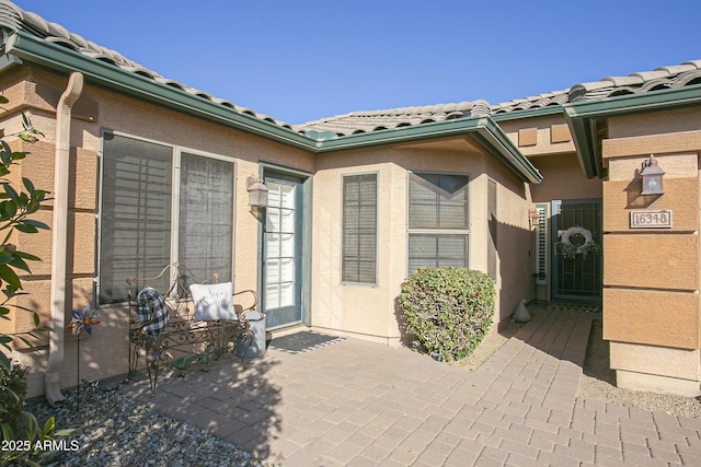 property entrance with a patio