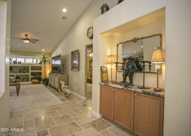 hallway featuring high vaulted ceiling