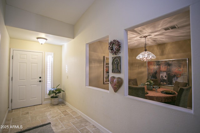 entryway featuring a notable chandelier