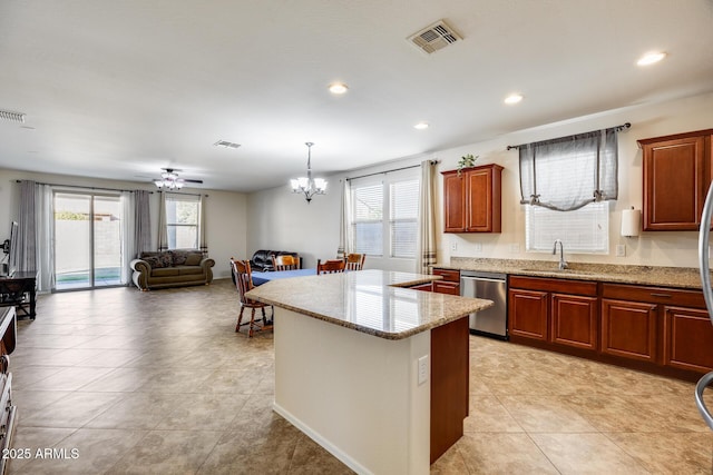 kitchen featuring sink, decorative light fixtures, plenty of natural light, and stainless steel dishwasher