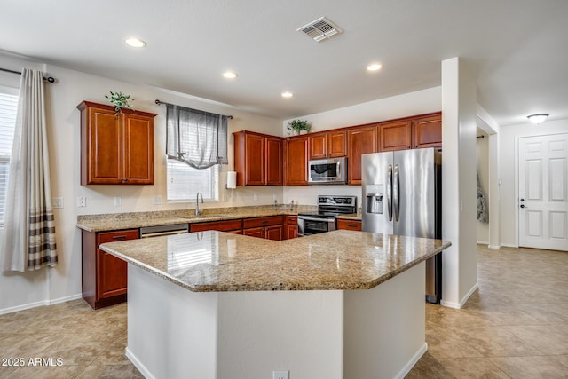 kitchen with plenty of natural light, a center island, and appliances with stainless steel finishes