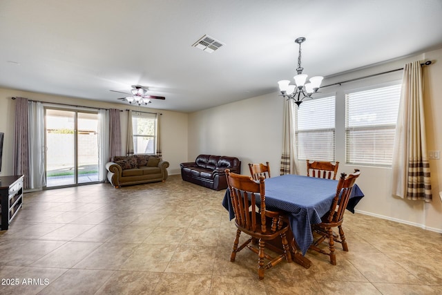 dining area with ceiling fan with notable chandelier and light tile patterned floors