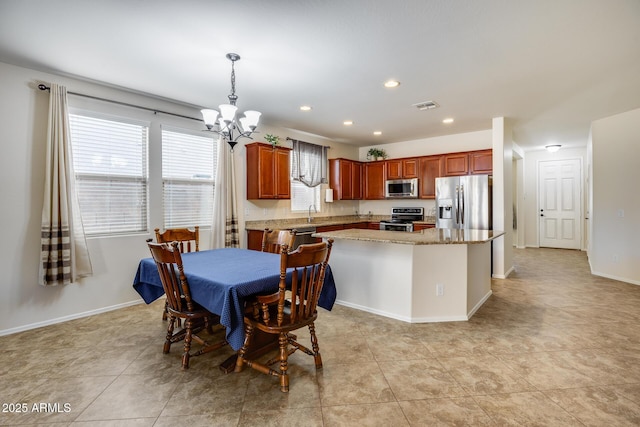 dining room featuring a notable chandelier, sink, and light tile patterned flooring