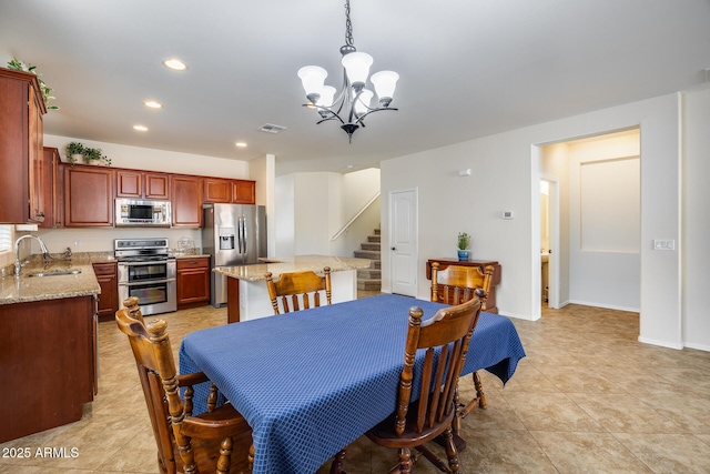 tiled dining area with sink and an inviting chandelier