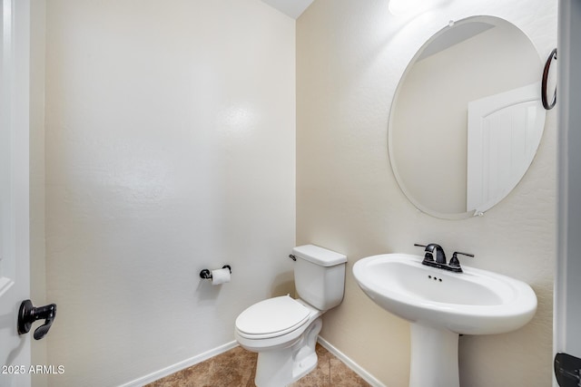 bathroom with toilet and tile patterned flooring