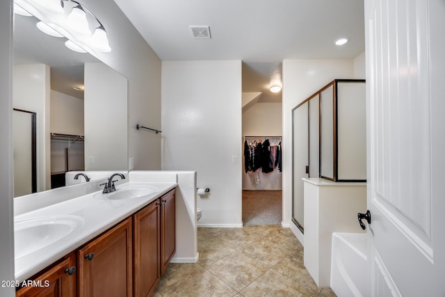 bathroom with vanity, toilet, a shower with door, and tile patterned flooring