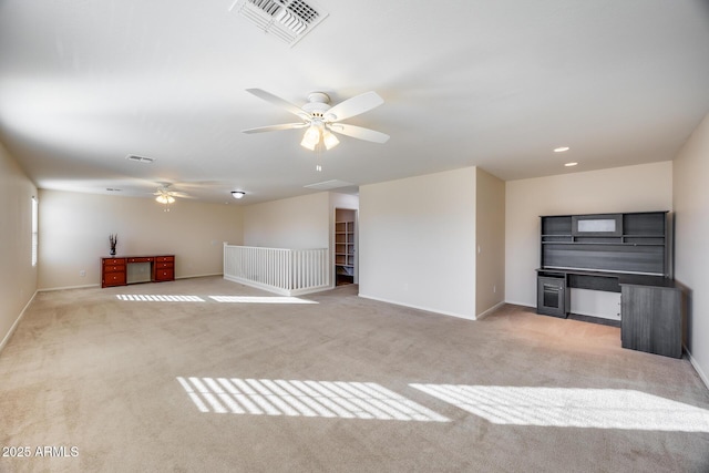 unfurnished living room with ceiling fan and light carpet