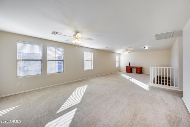 carpeted empty room featuring ceiling fan