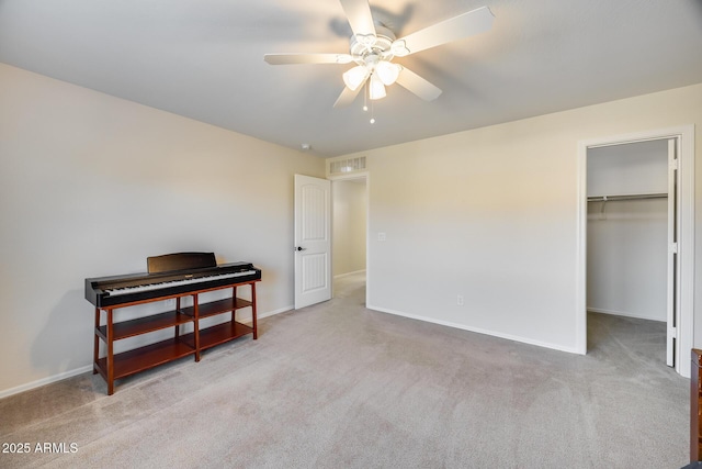 bedroom featuring ceiling fan, carpet, a spacious closet, and a closet