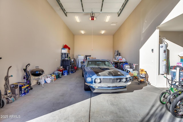 garage with a garage door opener and electric water heater