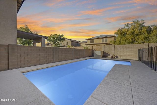 view of pool at dusk