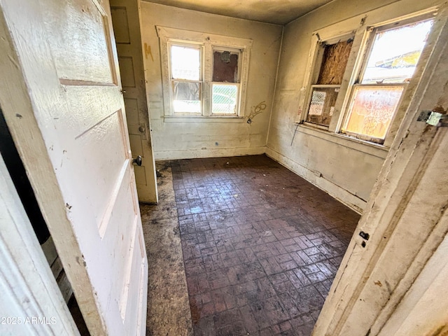 216 W Third St, Winslow, AZ 86047 - unfurnished room with brick patterned flooring