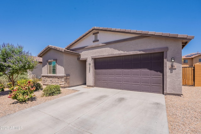948 E Wiley Way, Casa Grande, AZ 85122 - view of front of home with stucco siding, an attached garage, driveway, a tile roof, and stone siding