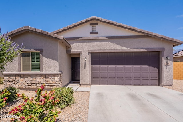 948 E Wiley Way, Casa Grande, AZ 85122 - view of front of house with stucco siding, a garage, concrete driveway, stone siding, and a tile roof