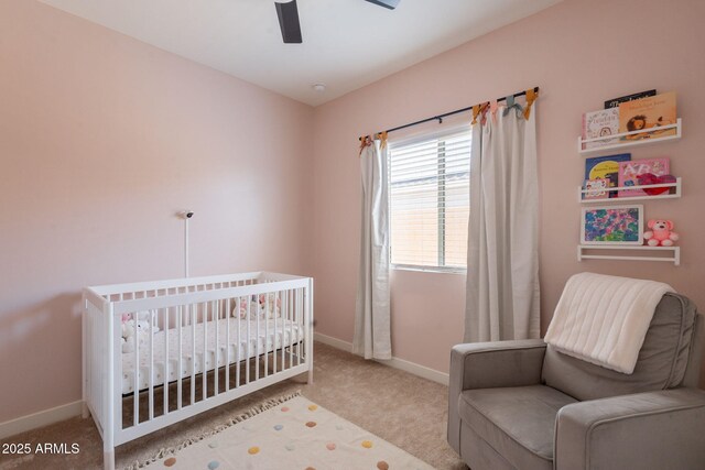 948 E Wiley Way, Casa Grande, AZ 85122 - bedroom featuring a nursery area, carpet floors, baseboards, and a ceiling fan