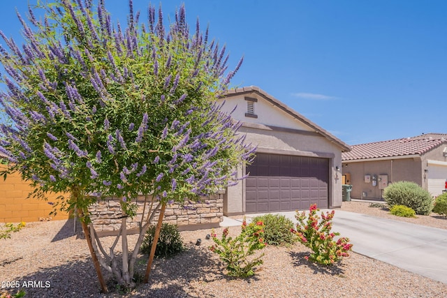 948 E Wiley Way, Casa Grande, AZ 85122 - view of front facade with stucco siding, an attached garage, concrete driveway, and a tile roof