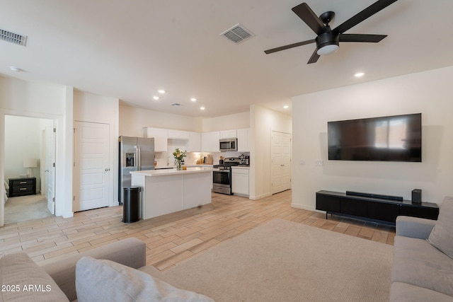 948 E Wiley Way, Casa Grande, AZ 85122 - living room featuring a ceiling fan, recessed lighting, and wood tiled floors