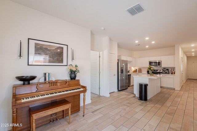 948 E Wiley Way, Casa Grande, AZ 85122 - kitchen with stainless steel appliances, white cabinets, light countertops, a center island, and recessed lighting