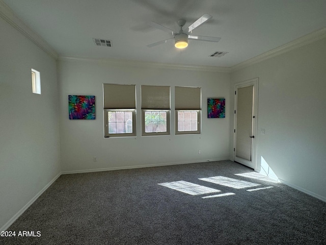 empty room featuring dark carpet, ceiling fan, and crown molding