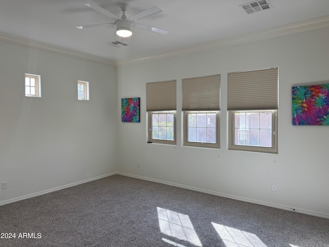 empty room featuring carpet floors, a healthy amount of sunlight, crown molding, and ceiling fan