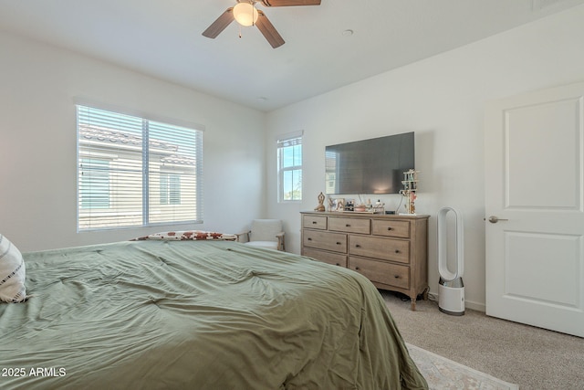 bedroom featuring light colored carpet and ceiling fan