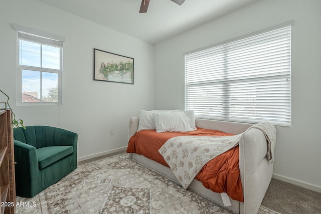 bedroom featuring ceiling fan and light carpet