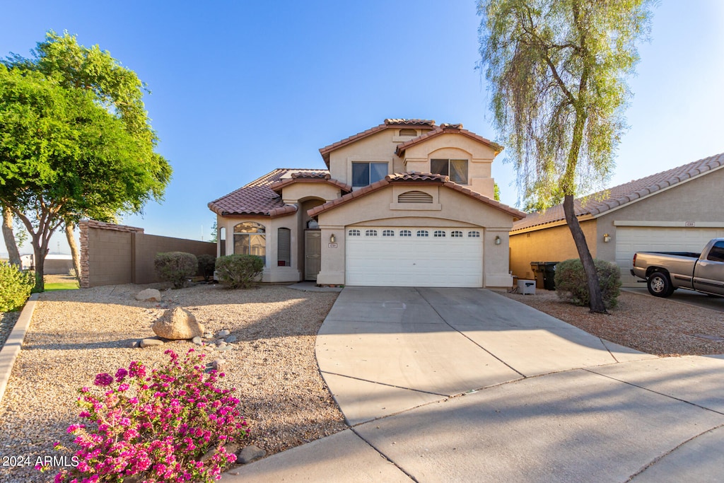 mediterranean / spanish house featuring a garage