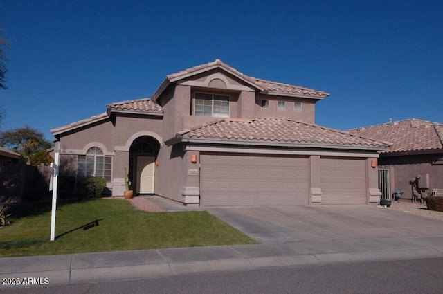 mediterranean / spanish home featuring an attached garage, a tiled roof, concrete driveway, stucco siding, and a front yard