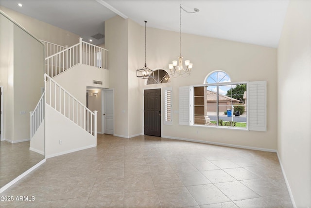 unfurnished living room with stairway, an inviting chandelier, high vaulted ceiling, and baseboards