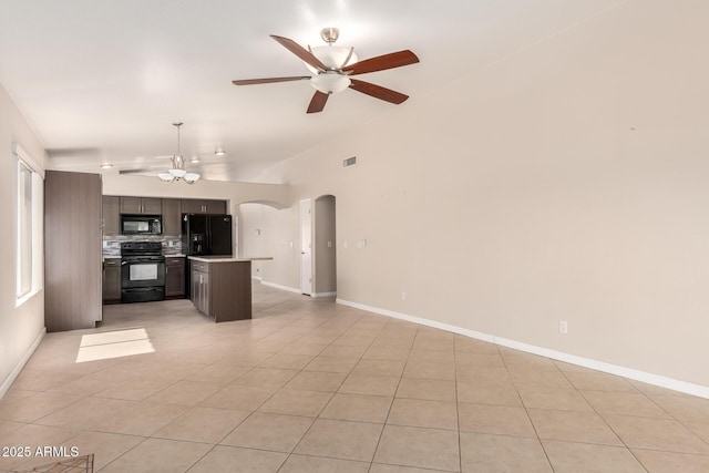 1379 E Butler Cir, Chandler, AZ 85225 - unfurnished living room featuring lofted ceiling, a ceiling fan, light tile patterned floors, arched walkways, and a chandelier