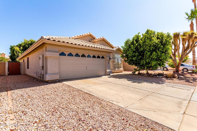 1379 E Butler Cir, Chandler, AZ 85225 - view of front of house with a tile roof, a garage, concrete driveway, and stucco siding