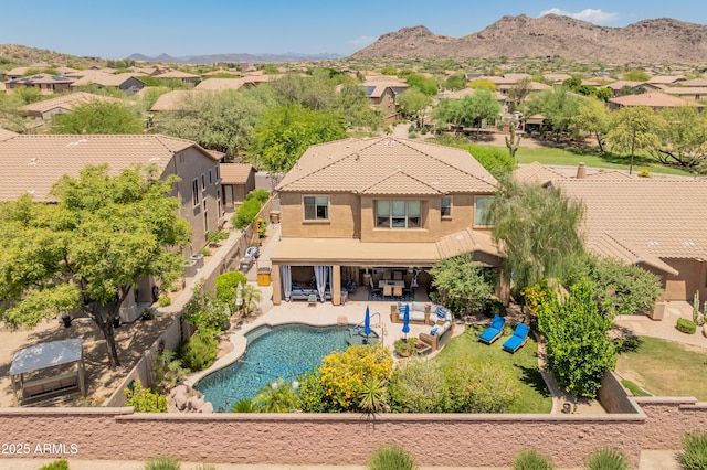 8447 W Tether Trl, Peoria, AZ 85383 - rear view of house with stucco siding, a fenced backyard, a residential view, a patio area, and a tile roof