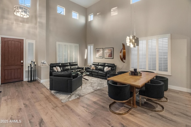 8447 W Tether Trl, Peoria, AZ 85383 - living room with a high ceiling, a chandelier, and wood finished floors