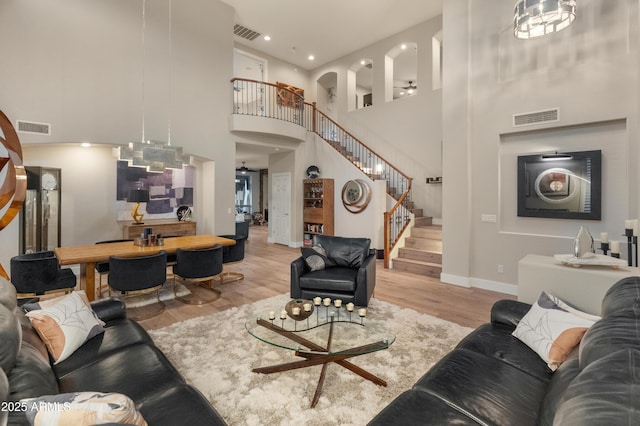 8447 W Tether Trl, Peoria, AZ 85383 - living room with a towering ceiling, stairs, wood finished floors, and recessed lighting