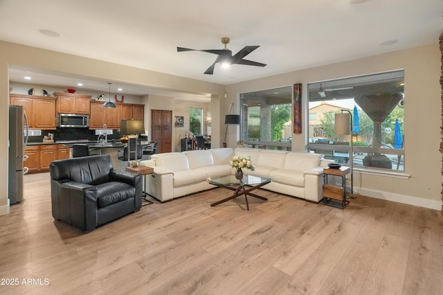 8447 W Tether Trl, Peoria, AZ 85383 - living area featuring light wood-type flooring and ceiling fan